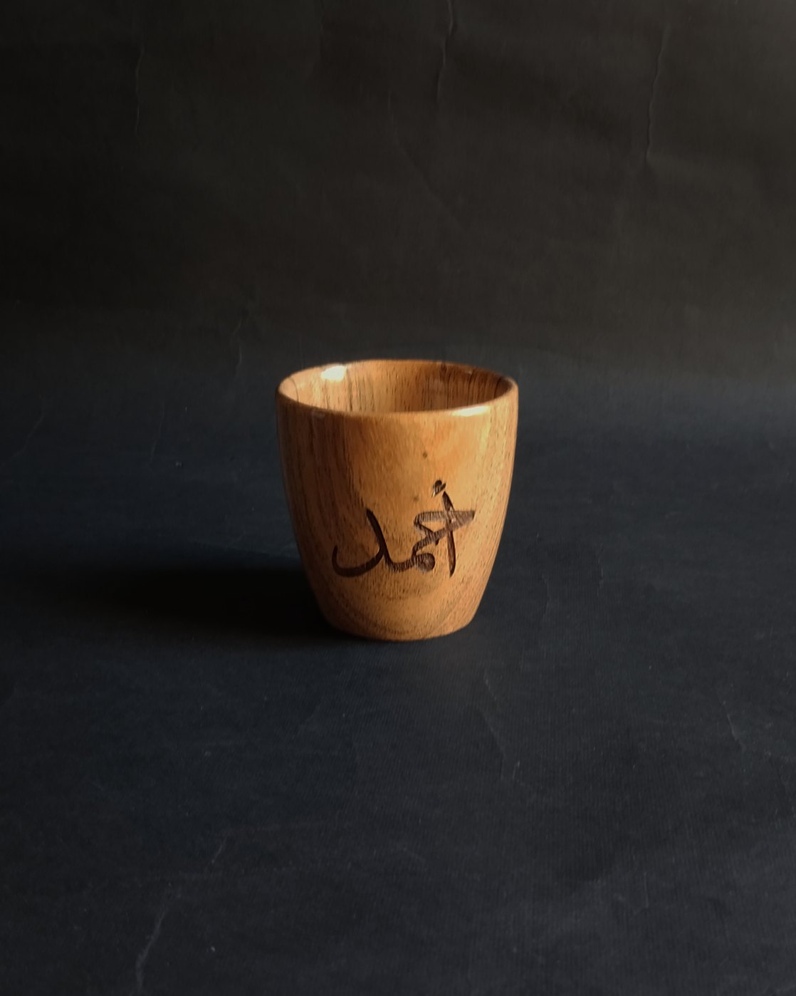 A cup and saucer engraved with Arabic calligraphy